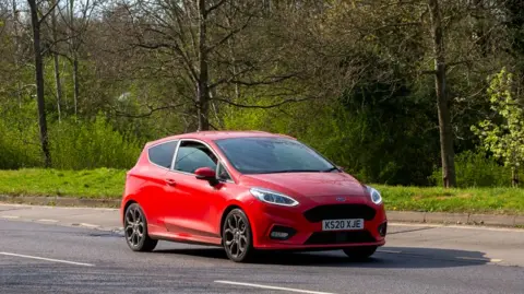 iStock Editorial / Getty Images A red Ford Fiesta on a British road.