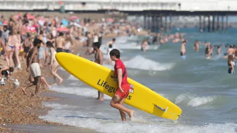A man with a surf board. 