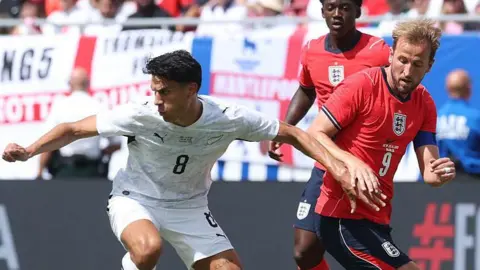 Marko Stamenic holds off Harry Kane 