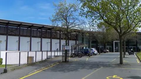 BBC Cars and bicycles can be seen in the car park outside Beau Sejour.