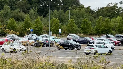 Richard Daniel/BBC Several cars parked in the car park 