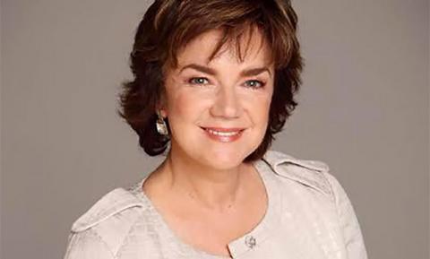 Publicity shot of a smiling Janet Andrewartha