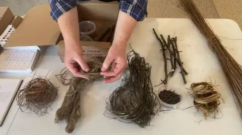 Kestle Barton A woman's hands with a number of items made out of natural products