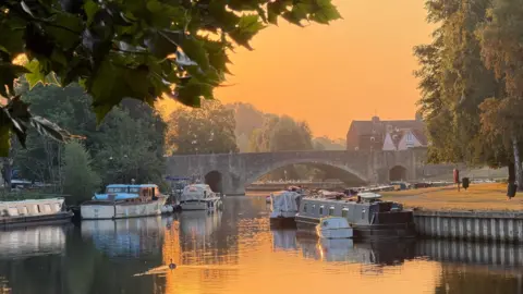 BBC Weather Watcher Becca C Boats line the River Thames at Abingdon as the sun rises