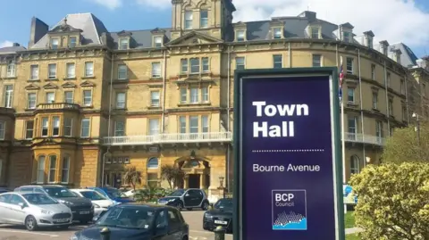 BCP Council Picture shows a large BCP Council sign outside their Bournemouth town hall. Cars can be seen parked outside the council hq.