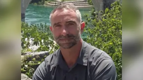 Family handout James Kirby sitting in front of some water