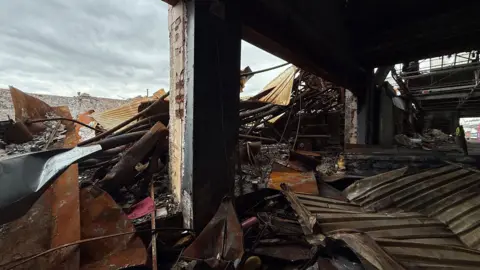 Inside a factory in Blakenhall, Wolverhampton, that was destroyed in a fire in January. Metal and rubble lies everywhere