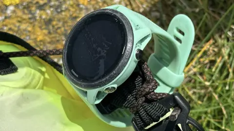 Sean Corcoran Close up image of the blue Garmin watch secured to the yellow floating device.