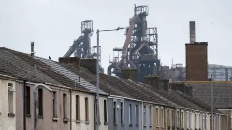 Getty Images The steelworks is in the background of a row of terrace homes. 