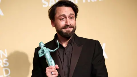 Kieran Culkin poses with the award for Best Performance by a Male Actor in a Supporting Role for "A Real Pain" at the 31st Screen Actors Guild Awards, in Los Angeles, California, U.S., February 23, 2025