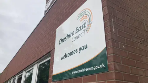 BBC A sign that says Cheshire East Council welcomes you