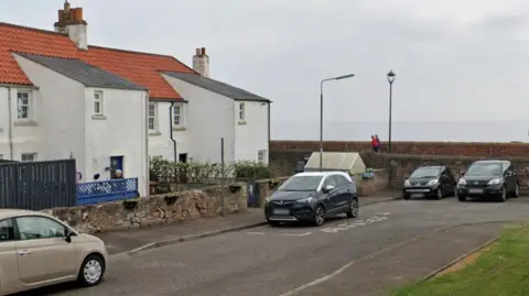 Google A row of white terraced houses.