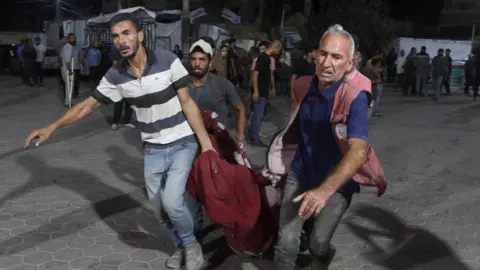 Getty Images Injured Palestinians are brought to al-Aqsa Hospital to receive medical care after an Israeli attack on a mosque near al-Aqsa Martyrs Hospital in Deir al-Balah, Gaza on 6 October, 2024