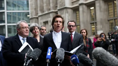 Reuters Lawyer David Sherborne flanked by former Deputy Leader of the Labour Party Tom Watson outside the High Court 