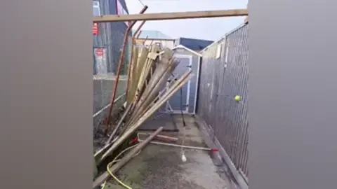 Berwick Animal Rescue Kennels A wooden fence is mangled and barely holding together.