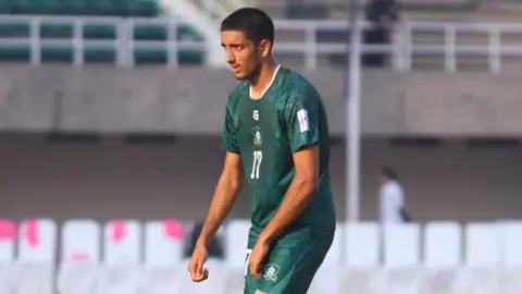 Ziyad Baig Umar Nawaz wears the dark green kit of the Pakistan national side as he awaits a pass from a team-mate. 