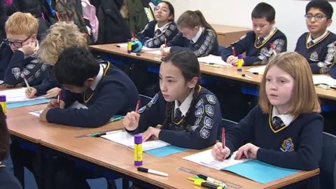 BBC A group of 10 and 11 year old pupils in a maths class