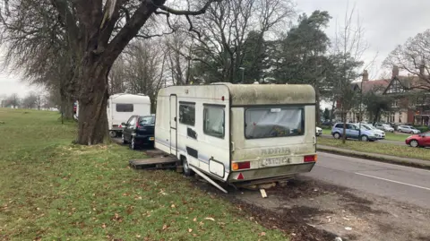 An archive photo showing a white caravan on the roadside of the Downs in Bristol.
