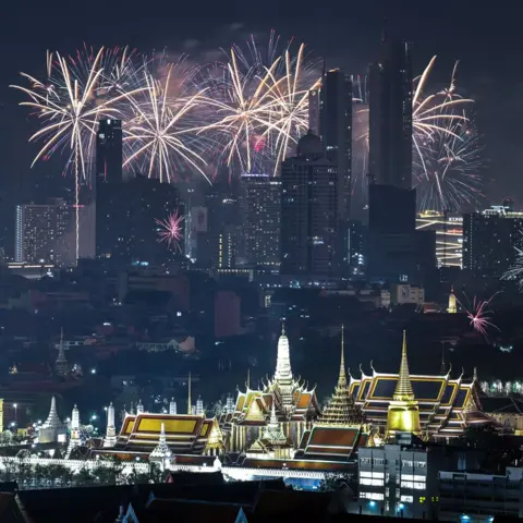 Athit Perawongmetha/REUTERS Fireworks explode over the Grand Palace during the New Year celebrations in Bangkok, Thailand, January 1, 2025. 