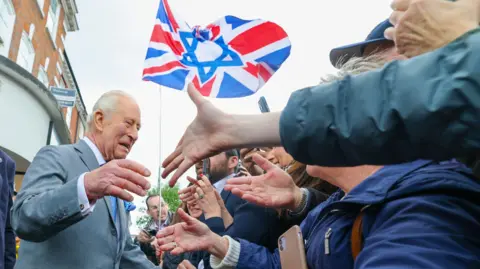 PA Media King Charles III during his visit to Golders Green, London, to show solidarity with the Jewish community. 