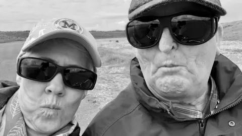 Supplied A black and white photo of Amanda and David pulling funny faces