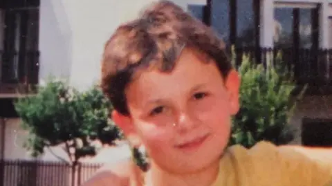Dalibor Sentic Childhood photo of Dalibor Sentic aged 10. He has short brown hair and is wearing a yellow t-shirt.