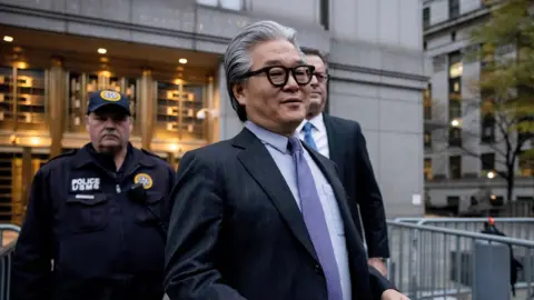 Bill Hwang, founder of Archegos Capital Management, exits federal court after being sentenced in New York.