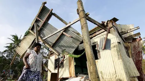 Getty Images A cyclone-damaged home in Fiji