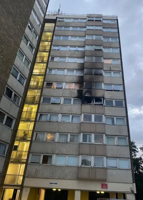 Essex Fire and Rescue Service Fire damage can be seen around the windows of a fourth-floor flat in an exterior photo of a 12-storey tower block