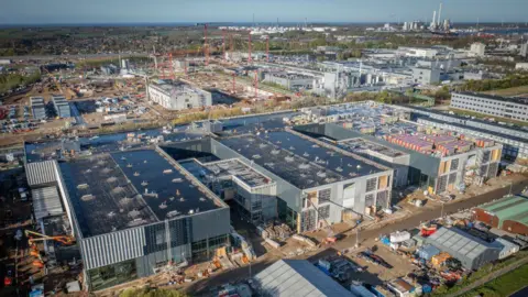 Getty Images Factories and red cranes tower over a huge building for the main production center of the weight-loss drug Wegovy, owned by the Novo Nordisk company.