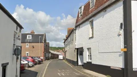 Bryanston Street in Blandford Forum, which is a residential street with a three-storey, white building on the right.