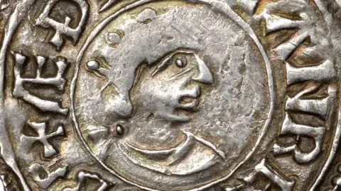 Athelstan Museum Close-up of a old silver coin with the head of a king