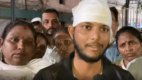 Akshay Vasant Patil seen with a bandage around his head