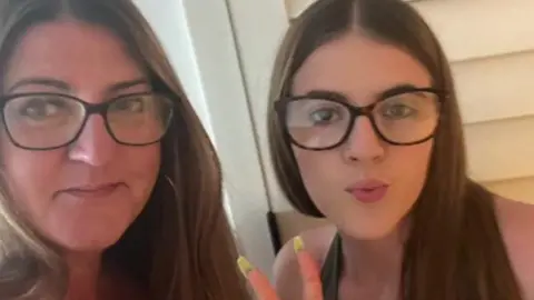 Claire Marshall Two women wearing glasses both with long brown hair