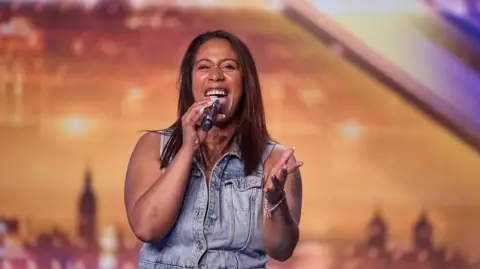 Tom Dymond Taryn Charles sings into a microphone on Britain's Got Talent