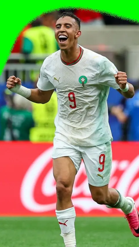 Soufiane Rahimi smiles with his fists in the air after scoring a third goal for Morocco against Canada in the 2026 World Cup.