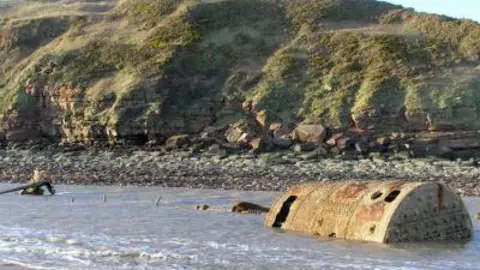 One of the boilers emerging from the sea at St Bees.