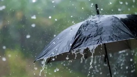 Getty Images Heavy rain on an umbrella