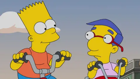 Bart Simpson and Milhouse cycling in a still from The Simpsons