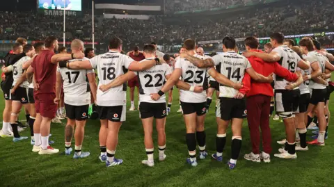 Wales players in a huddle after 43-0 defeat to South Africa