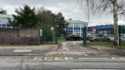 A school building next to a road.
