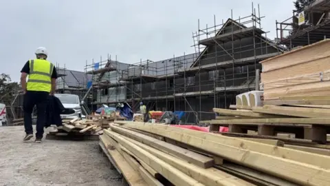 Wood piled up with houses being built