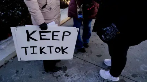 Getty Images A shot of the feet of protesters holds a "Keep TikTok" sign outside the US Supreme Court