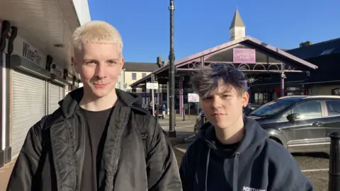 Two students, standing in Ballymoney town, near Castlecroft Square