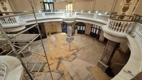 Stuart Woodward/BBC Inside the Kursaal building in Southend-on-Sea. This is the main entrance hall, with pillars around the side, white balconies and scaffolding