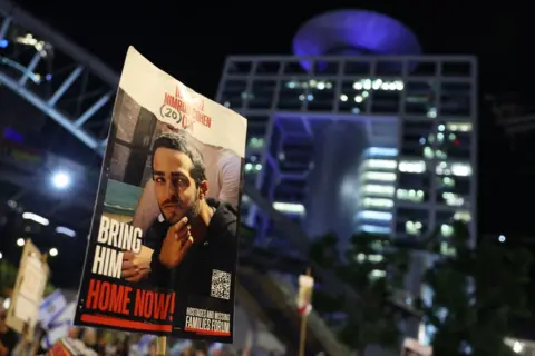 Getty Images A protester carries a portrait of Nimrod Cohen in October 2024.