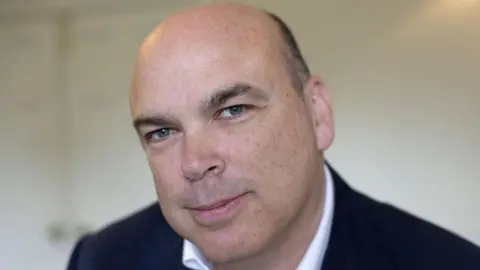 Getty Images A headshot of Mike Lynch, wearing a suit, from 2014