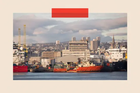 Bloomberg via Getty Images Vessels sit docked at Aberdeen Harbour, operated by the Aberdeen Harbour Board, as the city skyline is seen beyond in Aberdeen
