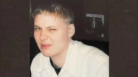 Derbyshire Police Picture of Izabela. She has short, fair hair and is wearing a beige jacket.