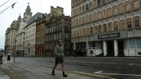 Reuters A man walks down an empty street.